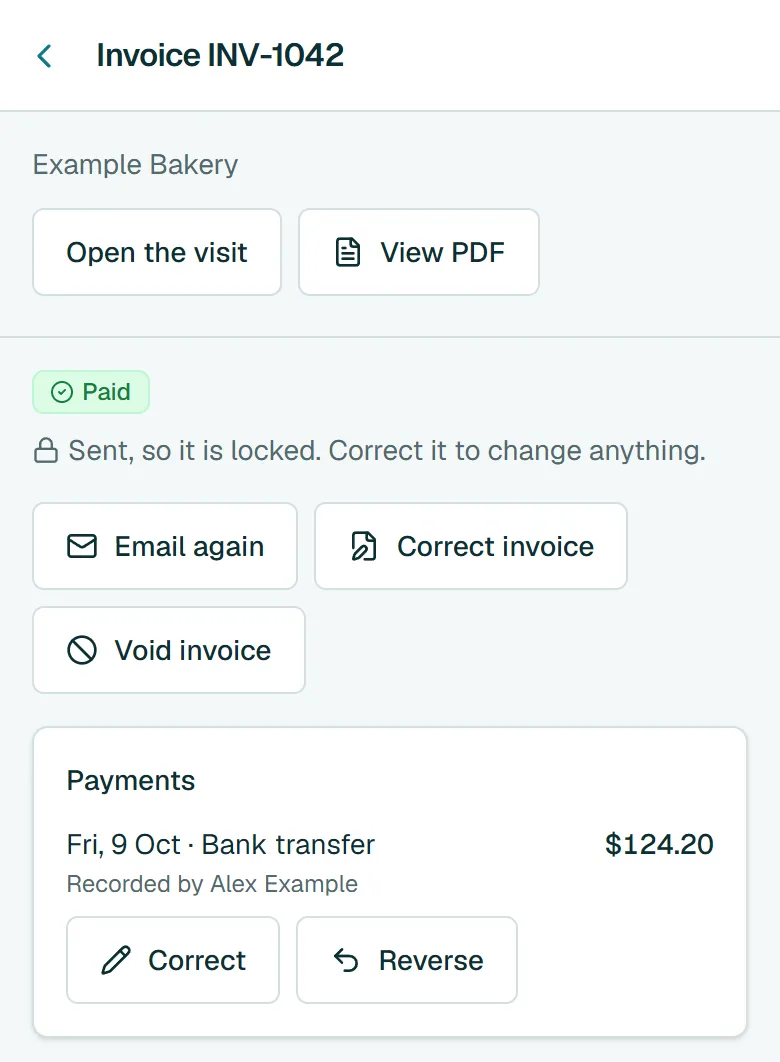An invoice marked paid, with a $124.20 bank transfer recorded under Payments.